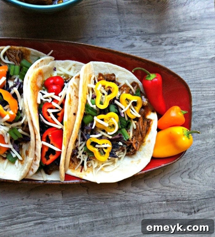 Slow-Cooked Mexican Red Chili Tacos 2 Crockpot tacos - tender beef, black beans, and corn in a flavorful red chili sauce for an easy weeknight meal
