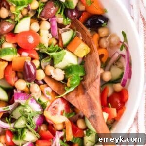 Mediterranean Chickpea Salad in a white bowl with spoon