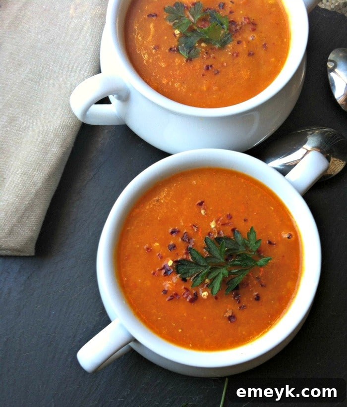 Vibrant Red Lentil Coconut Soup 3 A vibrant selection of fresh vegetables and spices laid out on a wooden board, ready for making Red Lentil Coconut Soup.