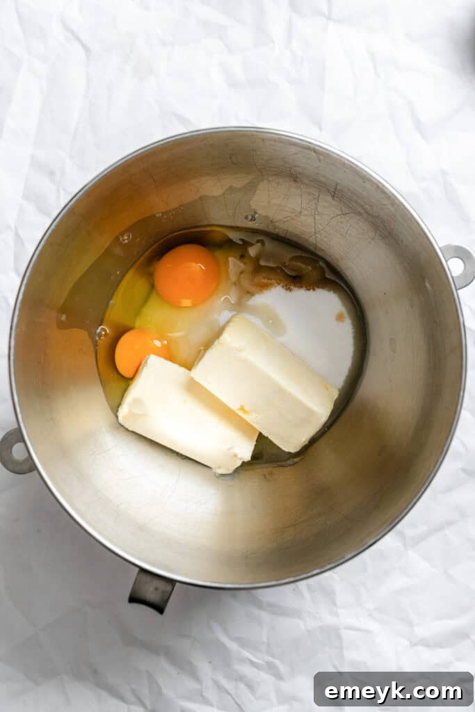 Easy Snickerdoodle Recipe wet ingredients in a mixing bowl: softened butter, sugar, and eggs.