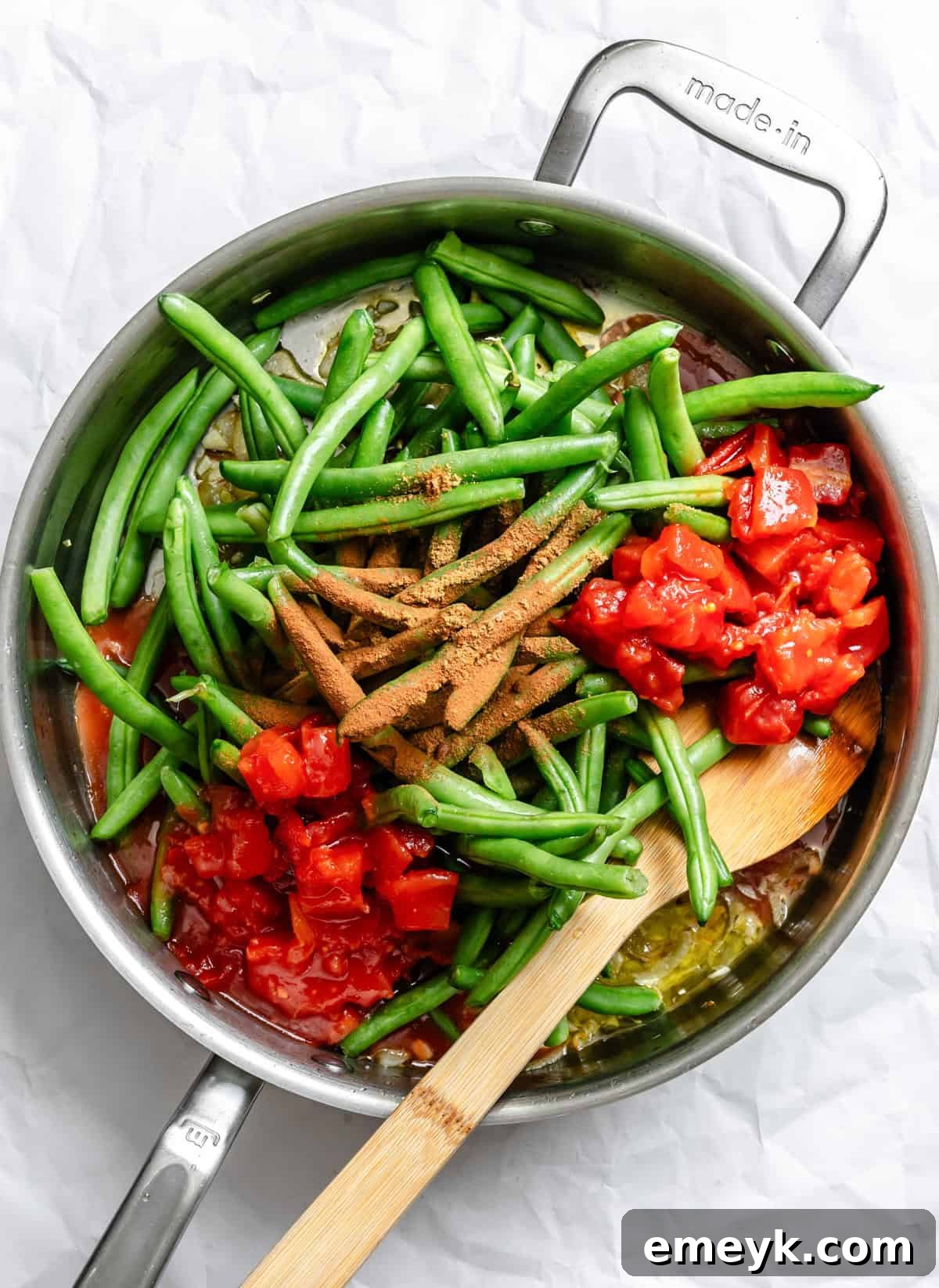Lebanese Green Beans simmering gently in a large skillet with a rich tomato sauce