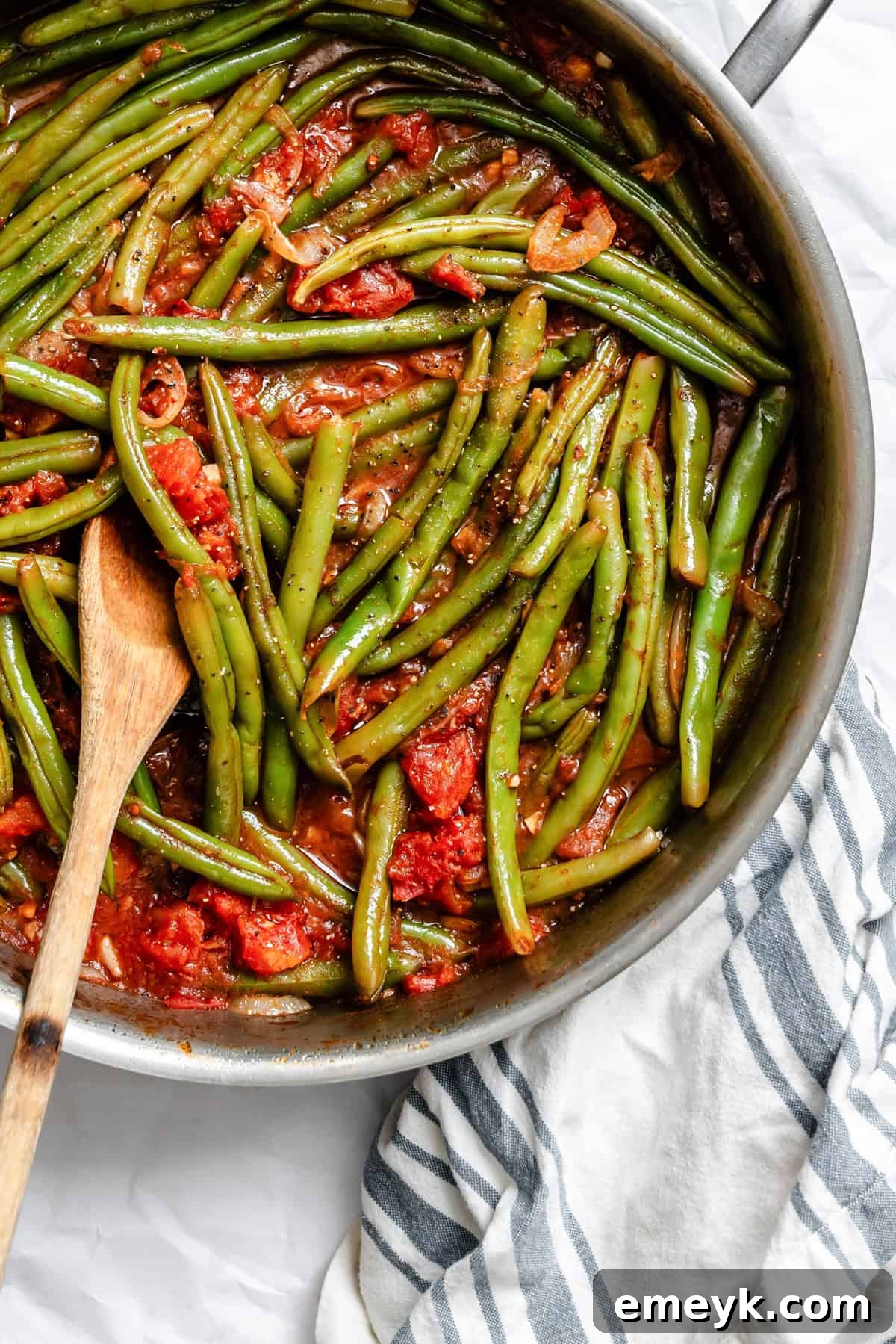 A close-up of Lebanese Green Beans in a skillet, showcasing the texture and rich color of the dish