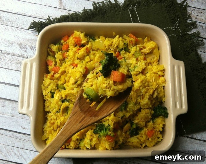 Hearty Curried Chicken and Rice Bake 3 Curried Chicken and Rice Casserole with a serving spoon