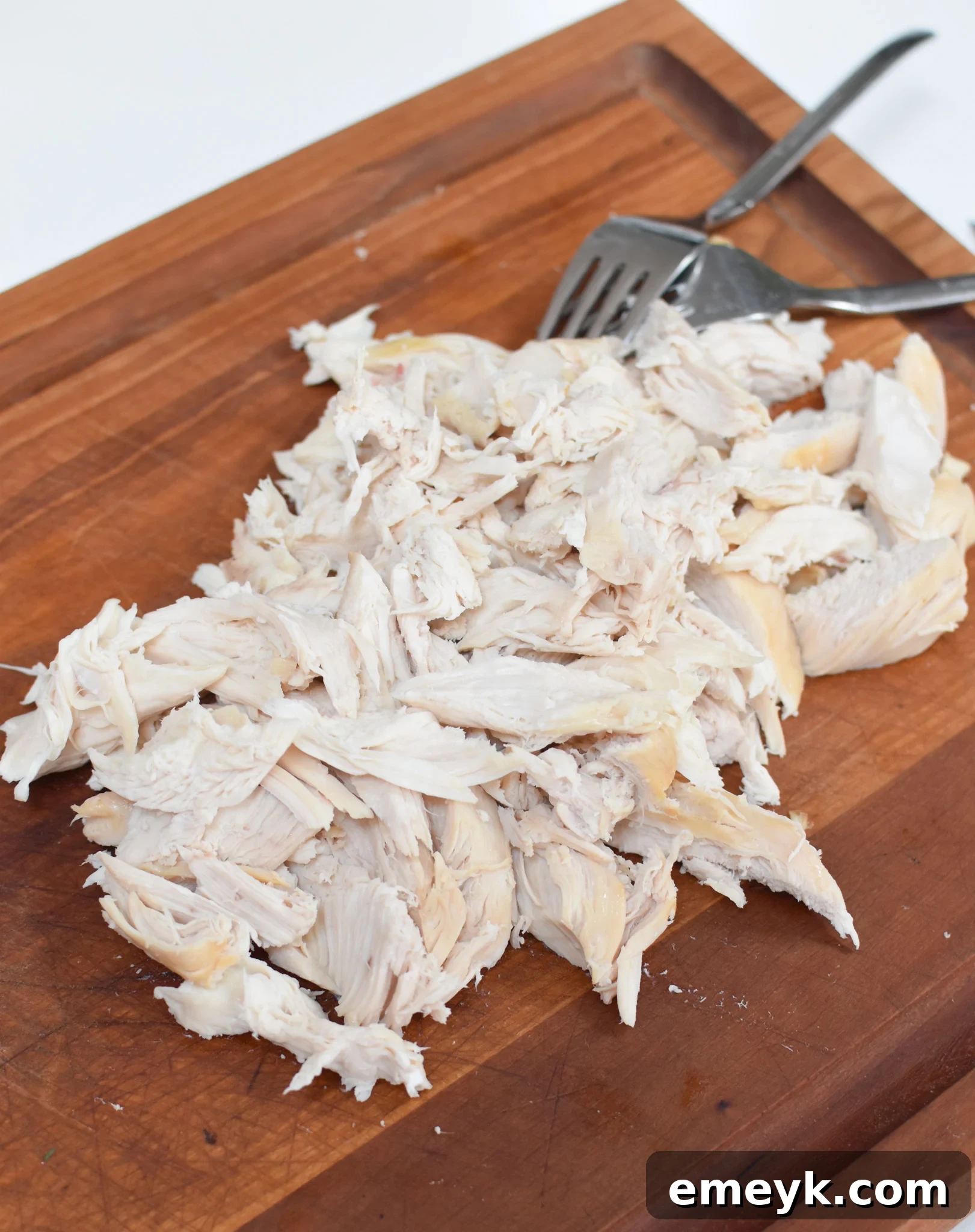 Sunshine Lemon Chicken Orzo Soup 7 Chopped chicken and ingredients for Lemon Chicken Orzo Soup on a cutting board.