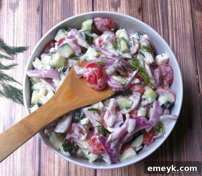 A large bowl of Cucumber Tomato Salad with Dill Yogurt Dressing, ready for serving