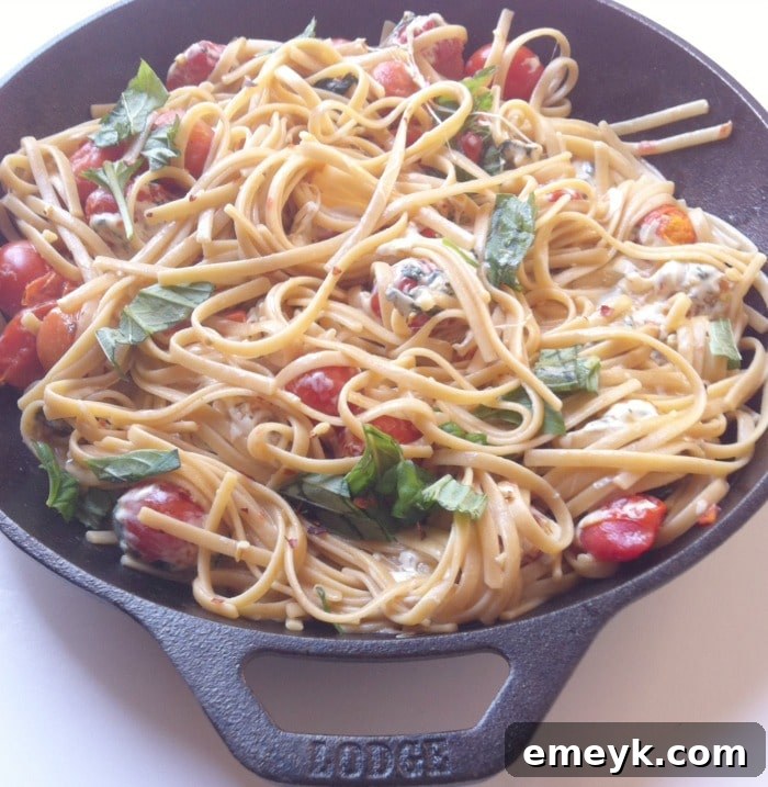 One Pan 30 Minute Caprese Pasta 4 Cooked Caprese Pasta Skillet garnished with fresh basil leaves