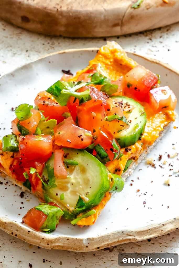 Finished Mediterranean Naan Pizza on a white plate, ready to be served