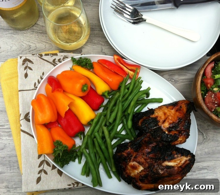 Spiced Honey-Lime Glazed Grilled Chicken 4 Sliced Spiced Honey Lime Grilled Chicken served with various colorful roasted vegetables, including bell peppers and zucchini.