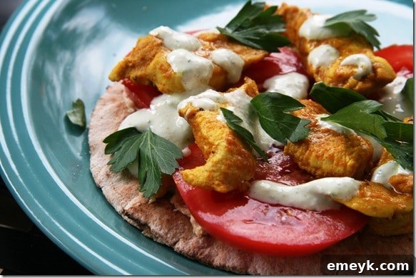 A beautifully presented Pita Pitza topped with tender chicken shawarma, fresh vegetables, and a drizzle of sauce, perfect as a light meal or appetizer.