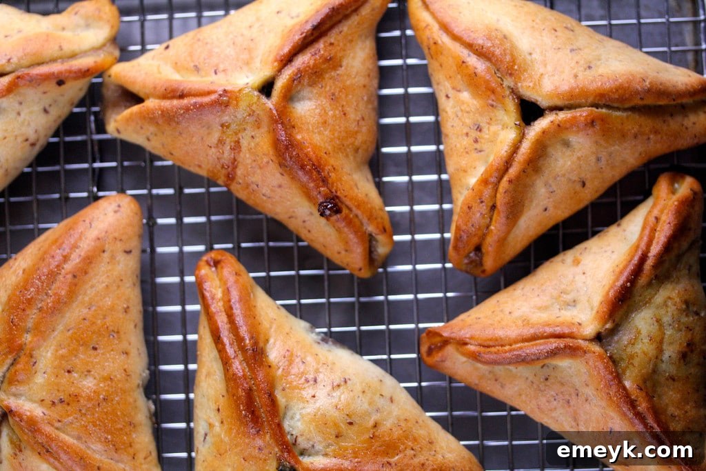 Assyrian Spinach Pies, individual boat-shaped pastries filled with a savory and spiced spinach mixture, presented beautifully on a platter.