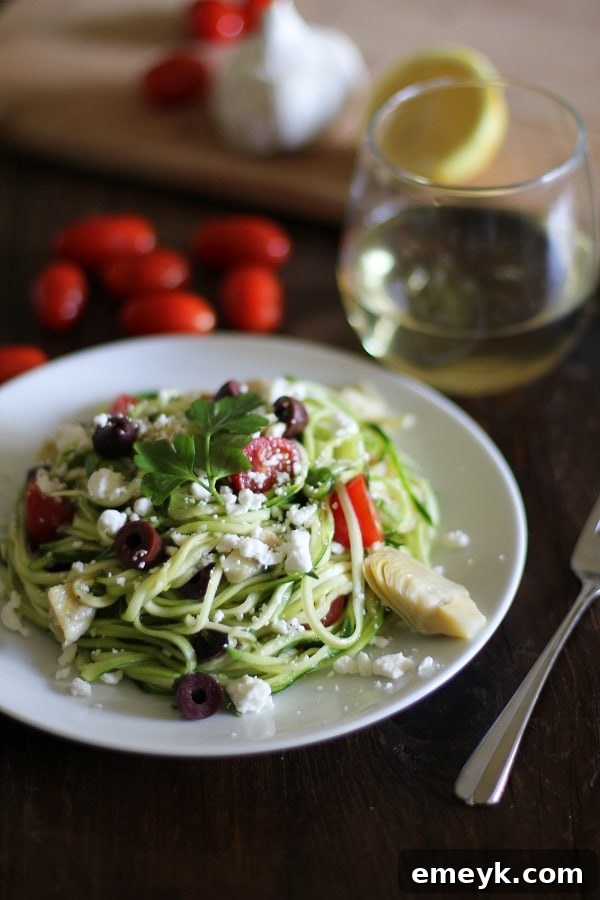 A delightful bowl of Mediterranean Zucchini Noodle Pasta, tossed with fresh tomatoes, olives, herbs, and feta cheese, offering a light and healthy meal.