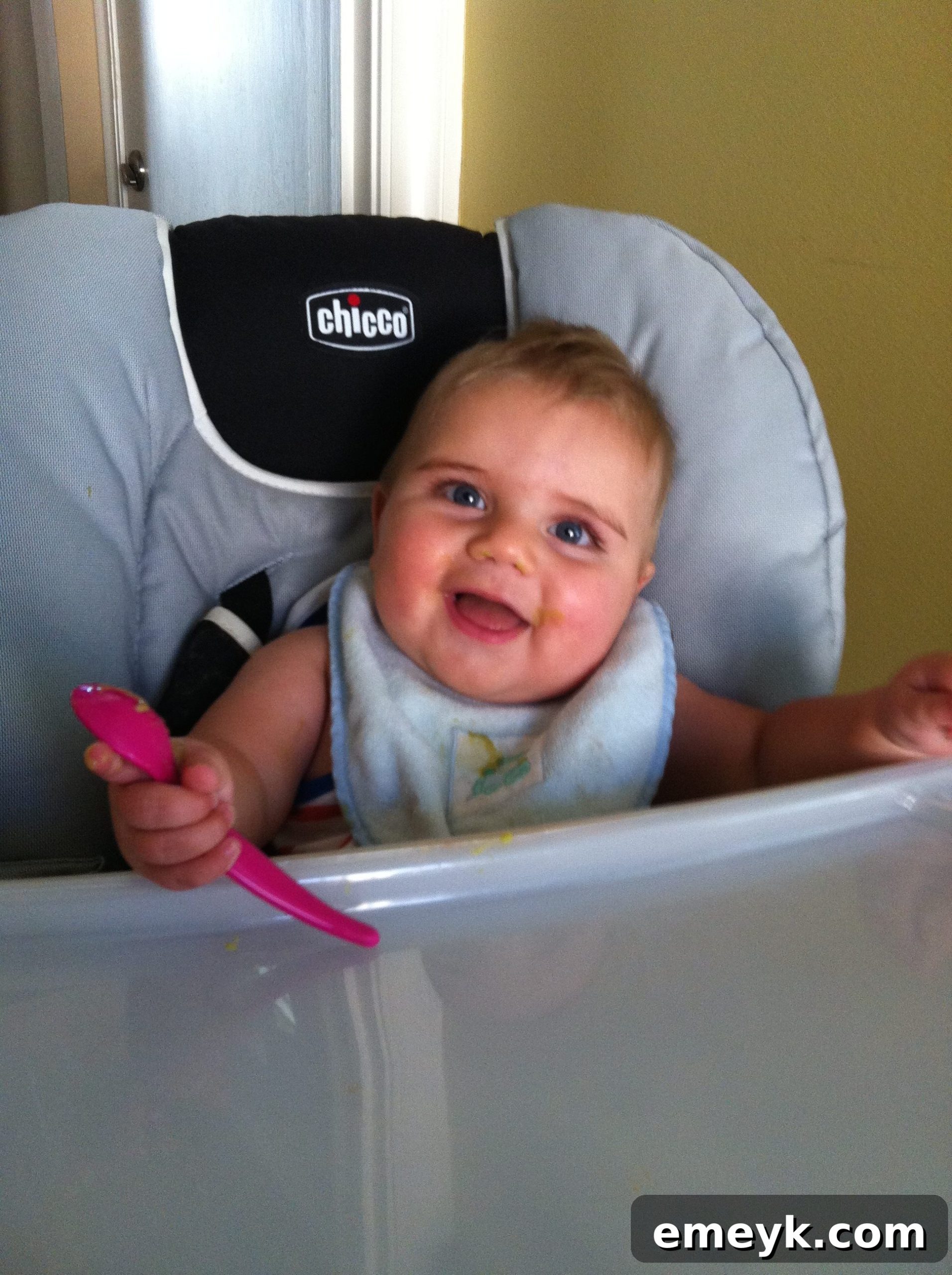 Andrew joyfully discovering solids, highlighting growth and new experiences.