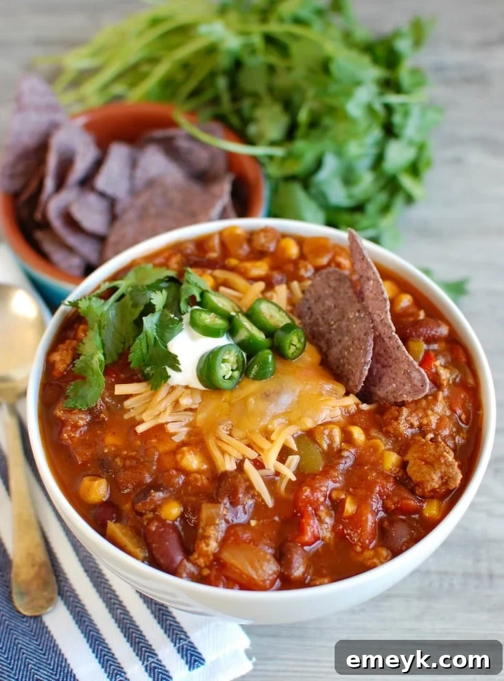 Hearty Slow Cooked Turkey Chili 2 Slow Cooker Turkey Chili served in a white bowl with toppings
