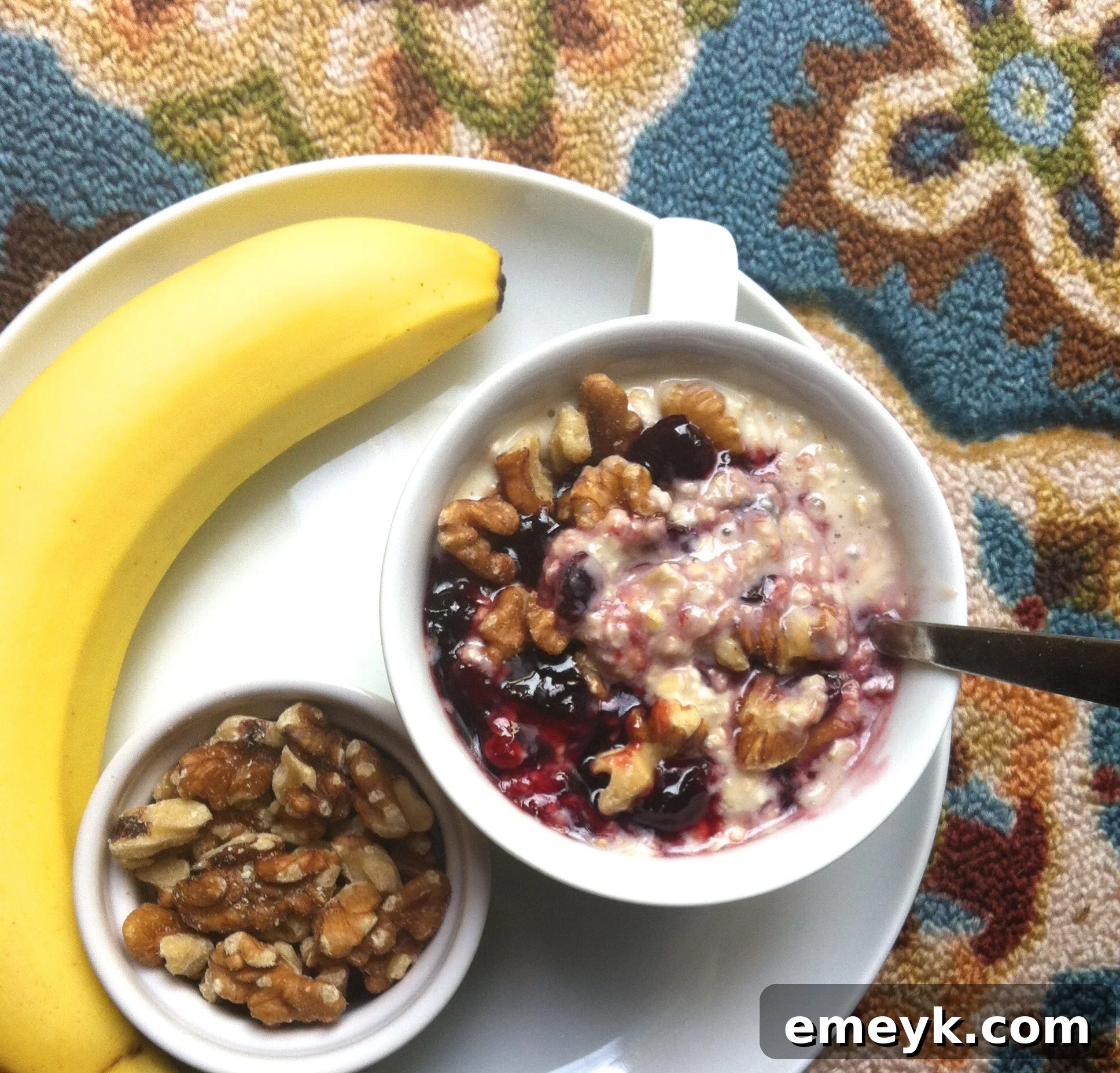 Creamy Cherry Overnight Oatmeal in a glass jar, ready to eat with a spoon