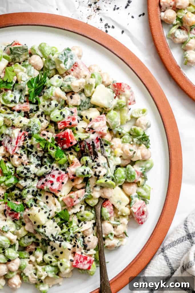 Edamame Chickpea Feta Salad on white plate with fork