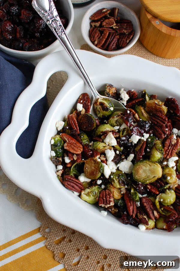 A festive platter of Roasted Brussels Sprouts with Cranberries, Blue Cheese, and Pecans, ready for serving.
