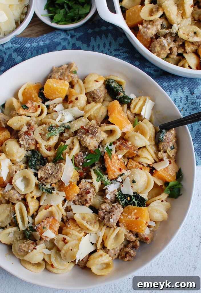 Golden Butternut Squash Pasta with Savory Sausage 7 Butternut Squash Pasta being twirled on a fork, showing its creamy texture