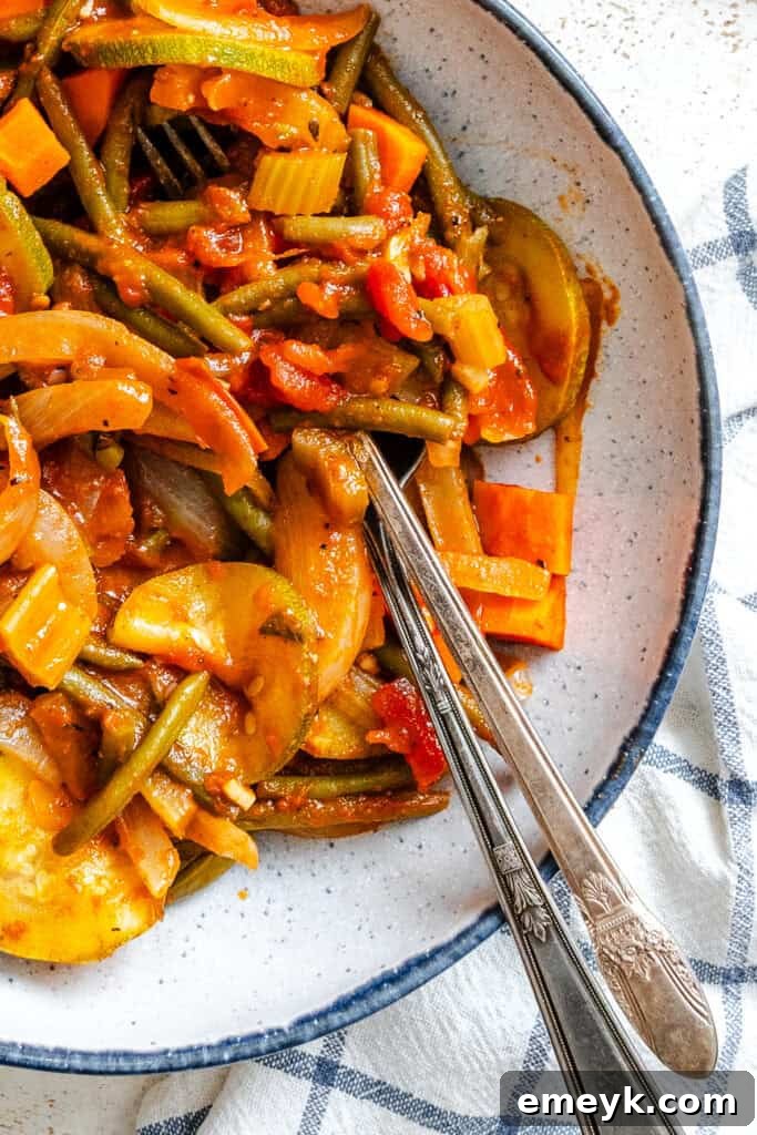 A bowl of Lebanese Vegetables (Loubieh bi Zeit) garnished with fresh herbs, ready to be served as a flavorful Mediterranean side dish.