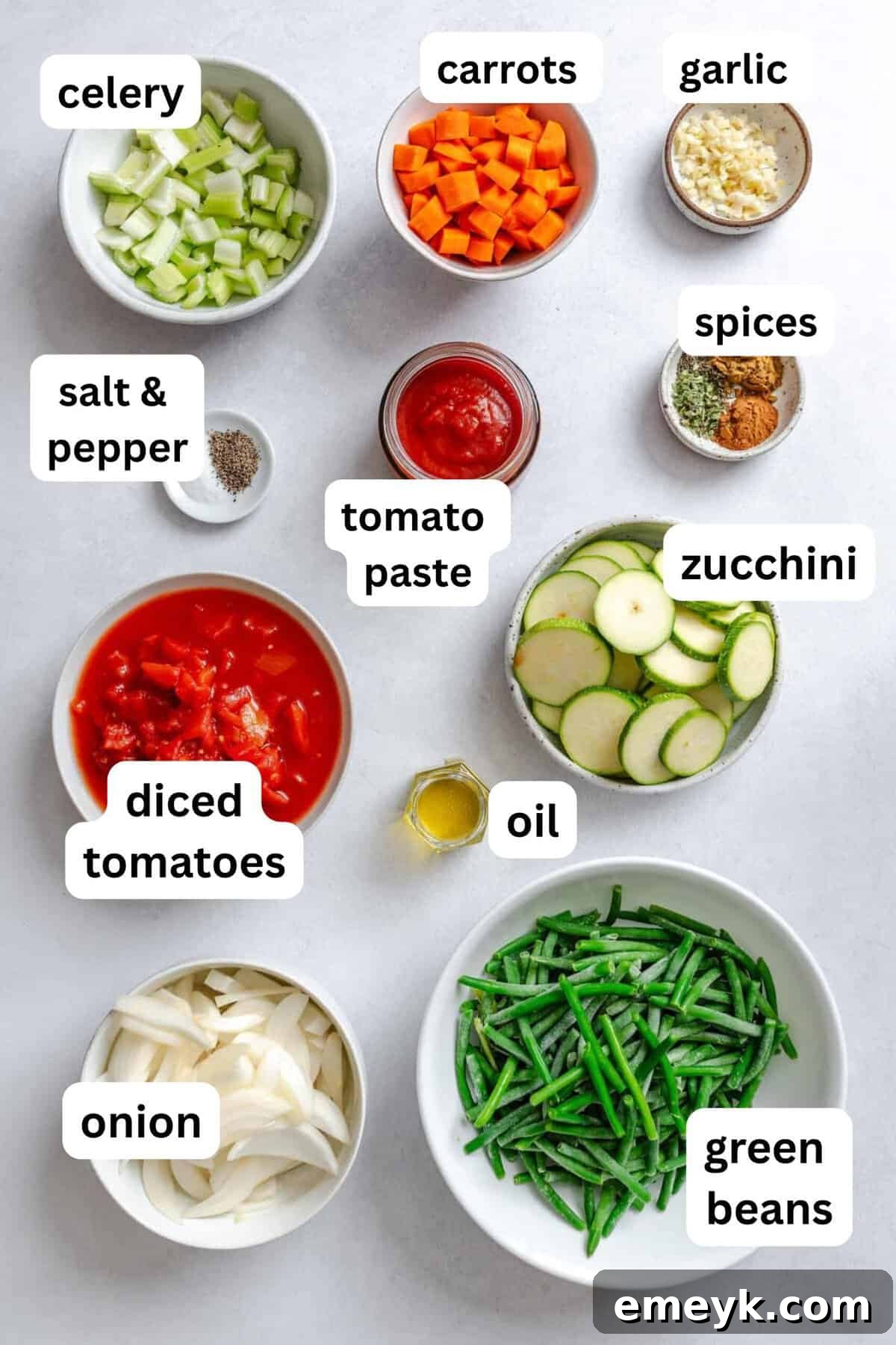 Fresh ingredients laid out for Lebanese Vegetables recipe, including vibrant green beans, zucchini, carrots, and onions, showcasing the dish's wholesome foundation.