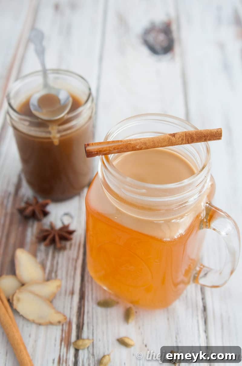 41 Festive Season Sips 5 A rustic mug of Cardamom Spiced Apple Cider, garnished with cinnamon sticks and star anise, perfect for autumn and winter celebrations.