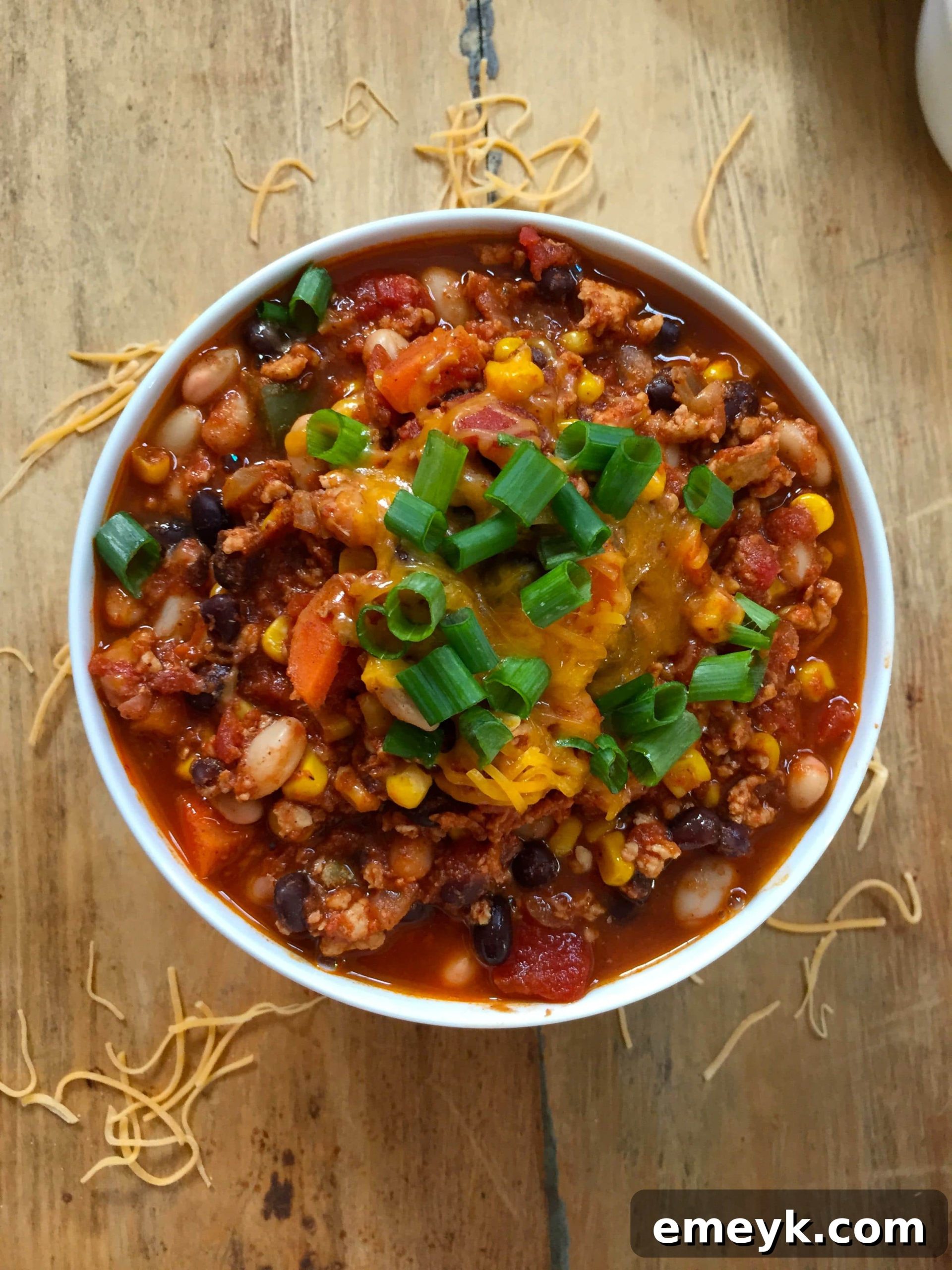 Hearty White and Black Bean Turkey Chili served in a bowl with toppings