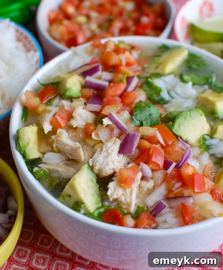 Slow-Simmered Mexican Lime Chicken Soup 2 A steaming bowl of Slow Cooker Mexican Chicken Lime Soup with fresh lime, cilantro, and avocado