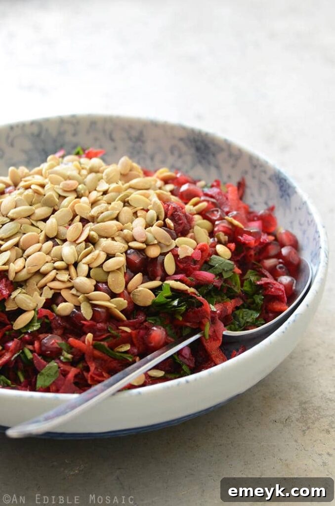 Embrace the Colors of Wellness 8 Beet and Carrot Salad with Pomegranate and Pumpkin Seeds, showing vibrant red beets, orange carrots, and shiny pomegranate arils