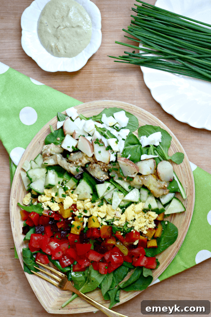 Embrace the Colors of Wellness 3 Rainbow Sabich Salad with Spicy Tahini Dressing, featuring layers of colorful vegetables, eggs, and a creamy tahini dressing