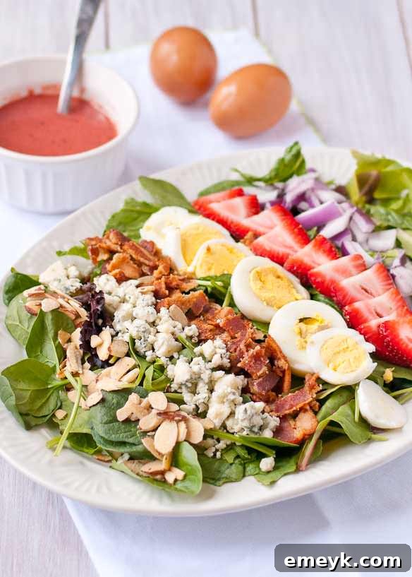 Embrace the Colors of Wellness 10 Strawberry Cobb Salad with Strawberry Bacon Vinaigrette, showcasing fresh strawberries, bacon, and greens