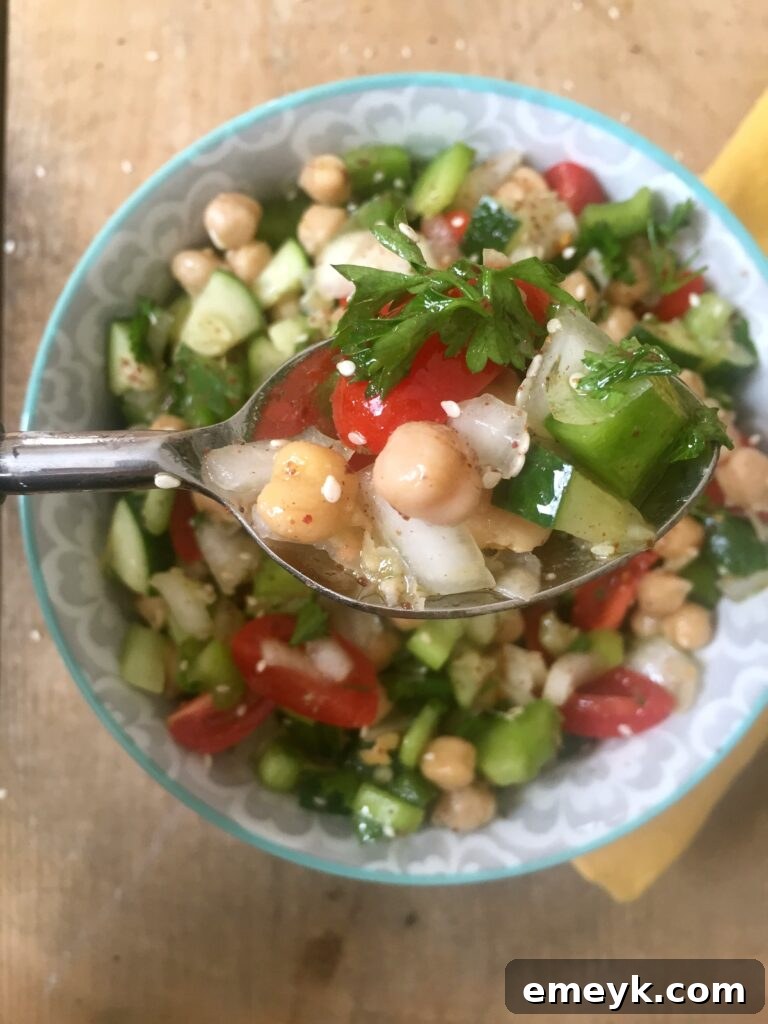 Embrace the Colors of Wellness 4 Close-up of a vibrant Chopped Chickpea Salad, featuring chickpeas, various chopped vegetables, and herbs