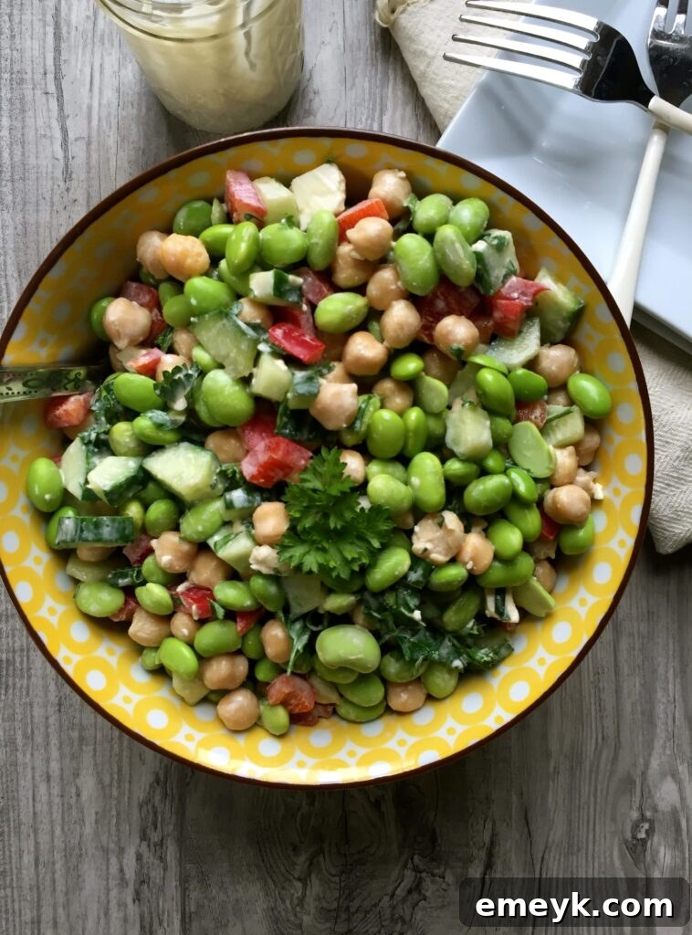 Embrace the Colors of Wellness 6 Edamame Chickpea Feta Salad with Tahini Dressing, showcasing green edamame, chickpeas, and crumbled feta