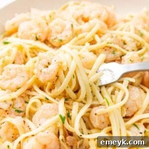 Lemon Garlic Shrimp Pasta in a bowl with a fork, ready to eat.