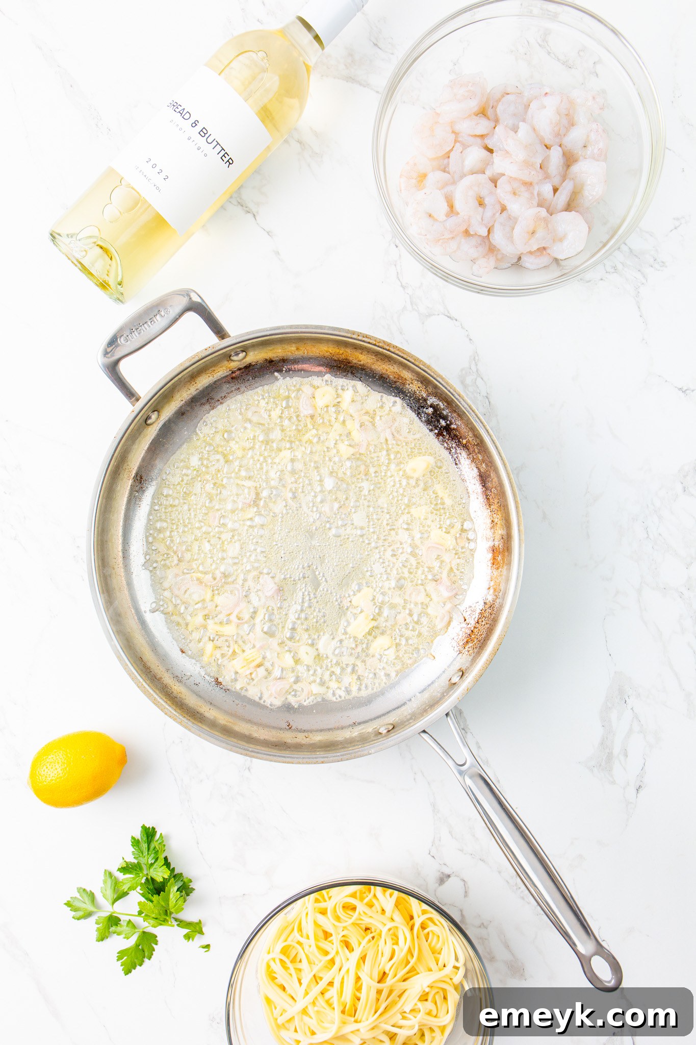 Finely chopped onion being sautéed in a skillet with butter and garlic for the Lemon Garlic Shrimp Pasta sauce.