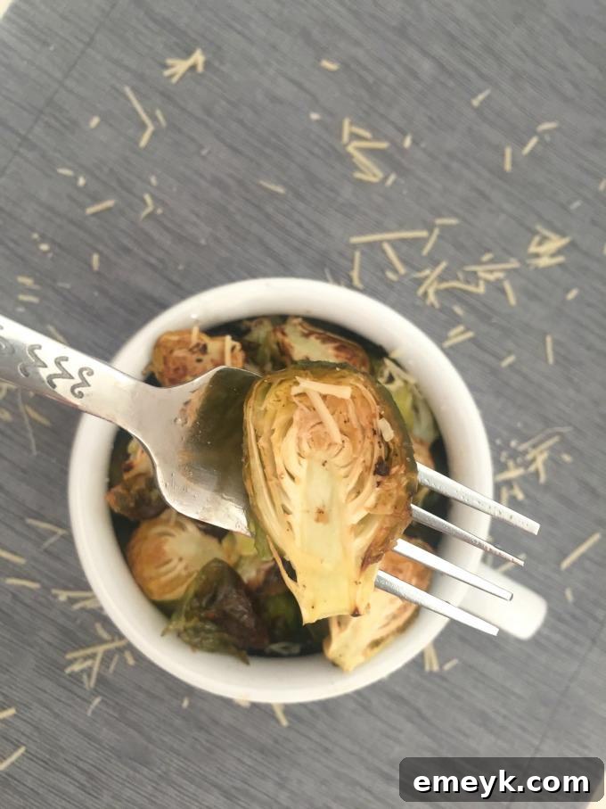 A child happily enjoying a plate of Brussels sprouts