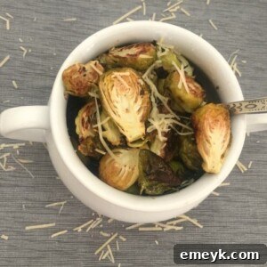 A serving of Lemon Garlic Roasted Brussels Sprouts with fresh lemon garnish