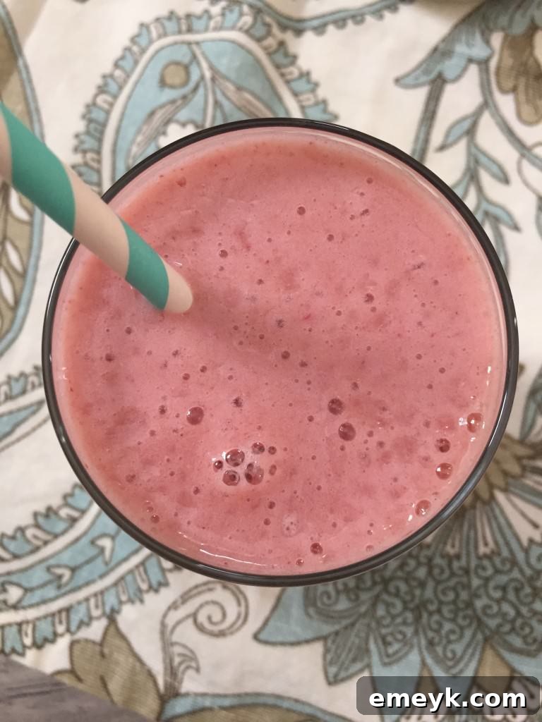 Overhead view of a Strawberry Cantaloupe Smoothie, highlighting its beautiful color and fresh fruit ingredients.