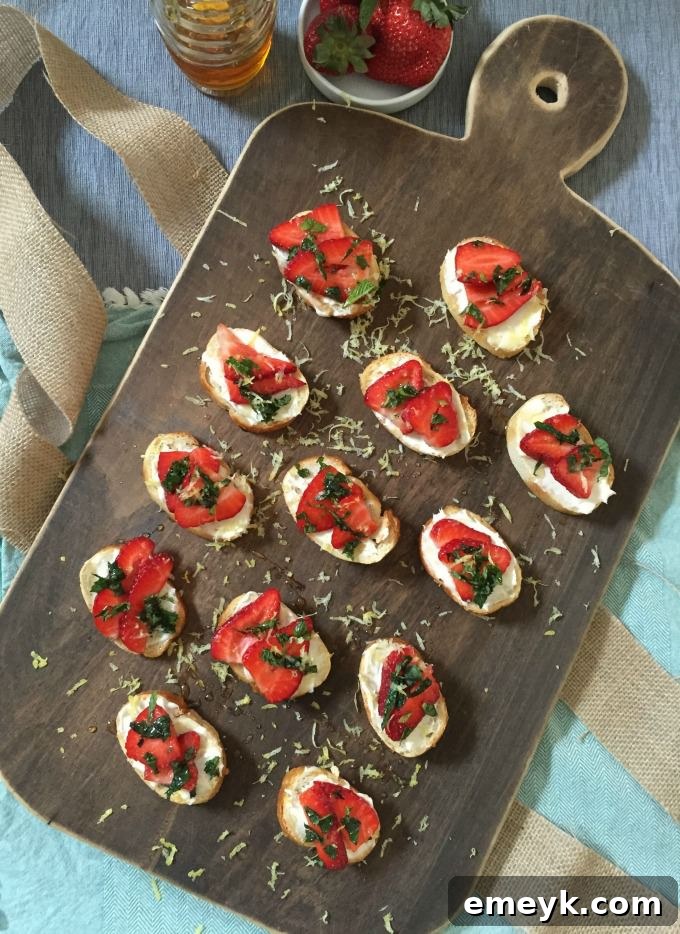 Velvet Strawberry Crostini with Mint and Zesty Honey 7 A close-up of a single Strawberry Mint Mascarpone Crostini, ready to be eaten.