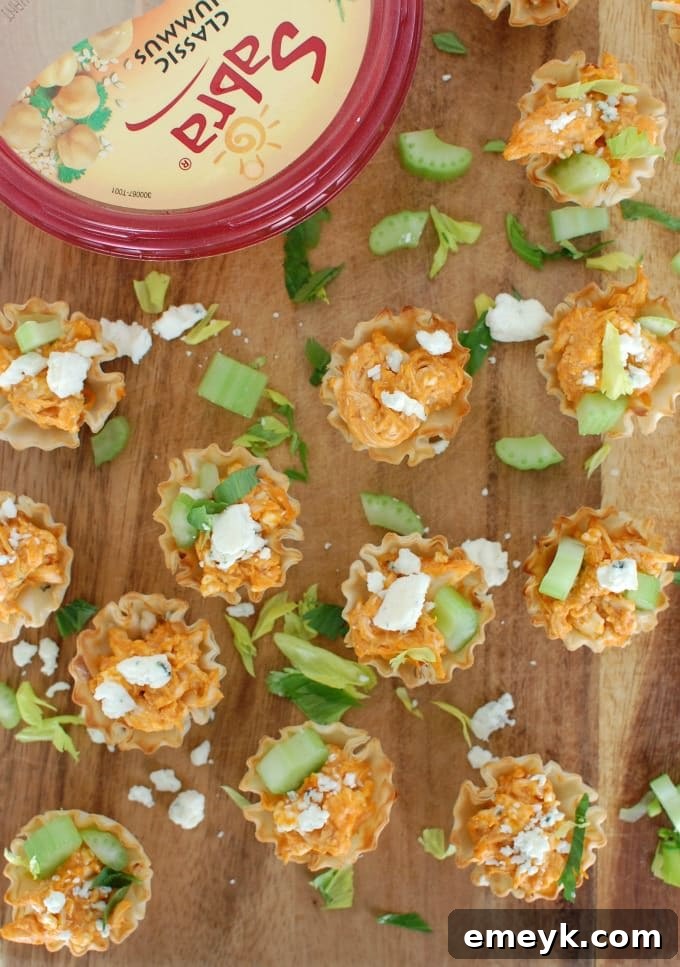Close-up of baked Buffalo Chicken Hummus Bites, showcasing the creamy filling and golden fillo crust.