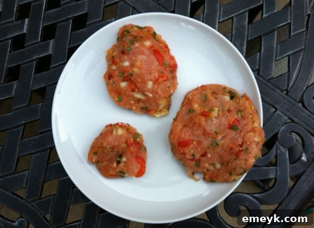 Raw turkey burger patties meticulously arranged on a grill rack, ready to be cooked