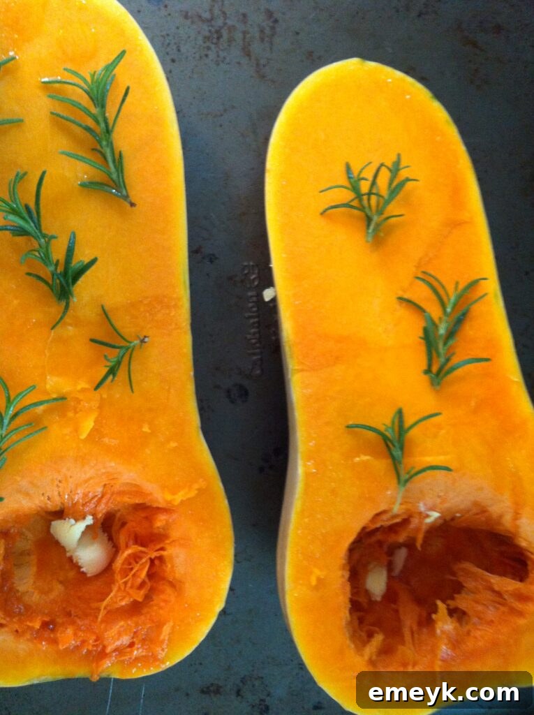 Butternut Squash with Rosemary and Butter Rosemary sprigs and butter placed in butternut squash halves