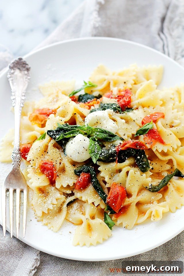 Close-up of One-Pot Caprese Pasta Recipe Dinner from Diethood, featuring fresh tomatoes, mozzarella, and basil.
