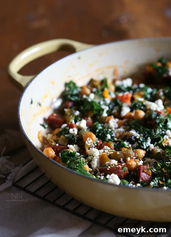 Chorizo Chickpea Skillet, a flavorful dish with spicy chorizo, chickpeas, kale, bell peppers, and cotija cheese.