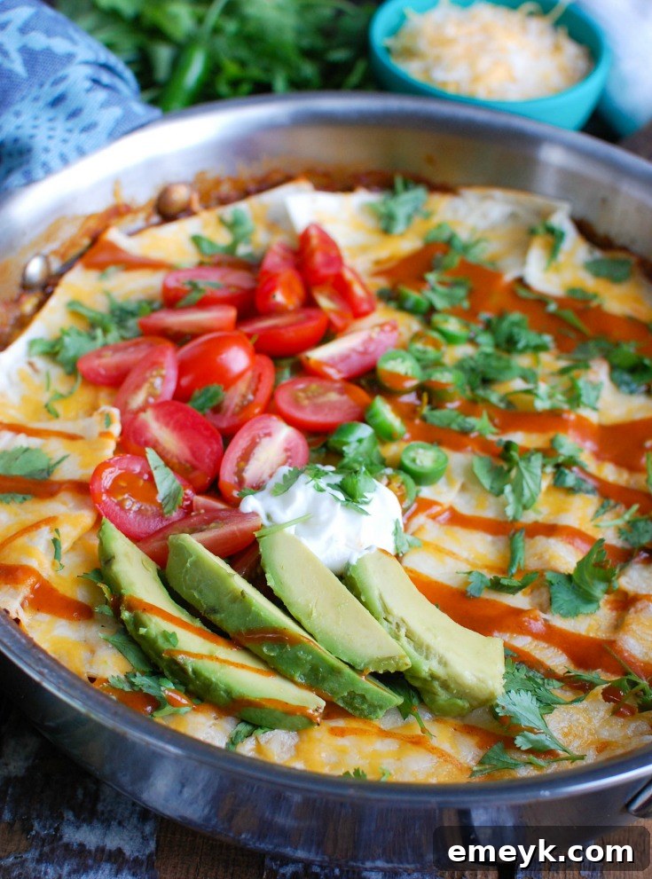 Delicious One Pot Beef Enchilada Casserole, cooked with ground beef, enchilada sauce, tortillas, vegetables, and cheese in a single pot.