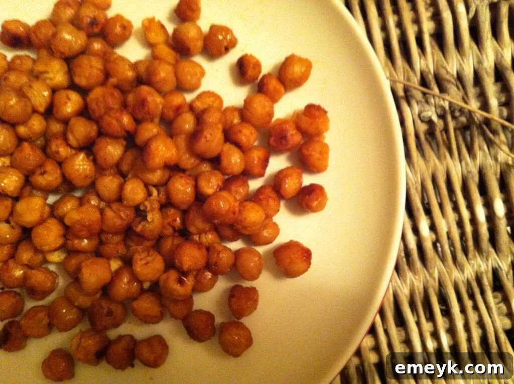 Deliciously seasoned roasted chickpeas on a rustic plate, ready to be enjoyed as a healthy snack or appetizer.