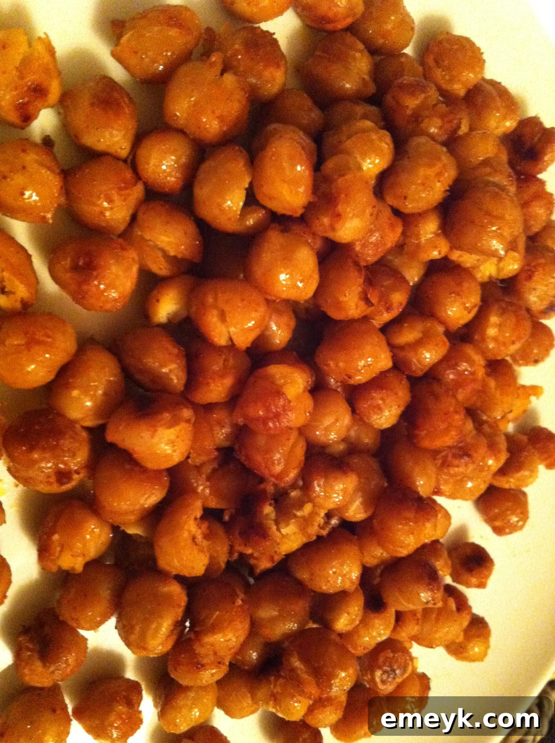 A close-up view of perfectly roasted chickpeas, highlighting their golden color and irresistible crispy texture.