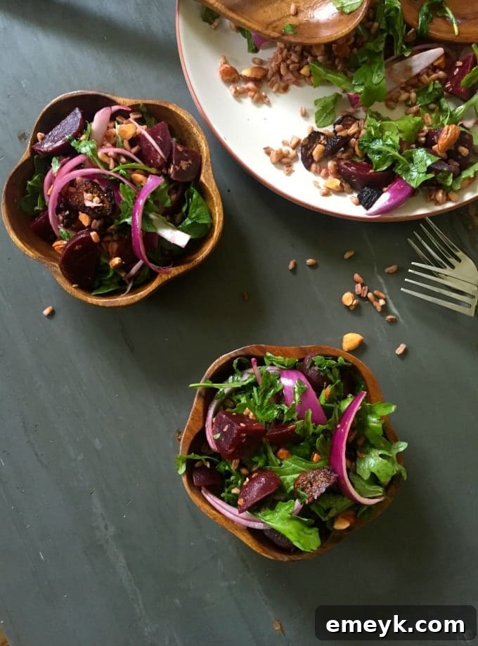 Hearty Farro Salad with Roasted Beets and Arugula 5 A bowl of Farro Roasted Beet Arugula Salad with a rustic background, highlighting fresh ingredients.