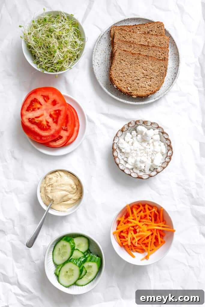 Assortment of fresh ingredients for Mediterranean Vegetable Sandwich laid out.