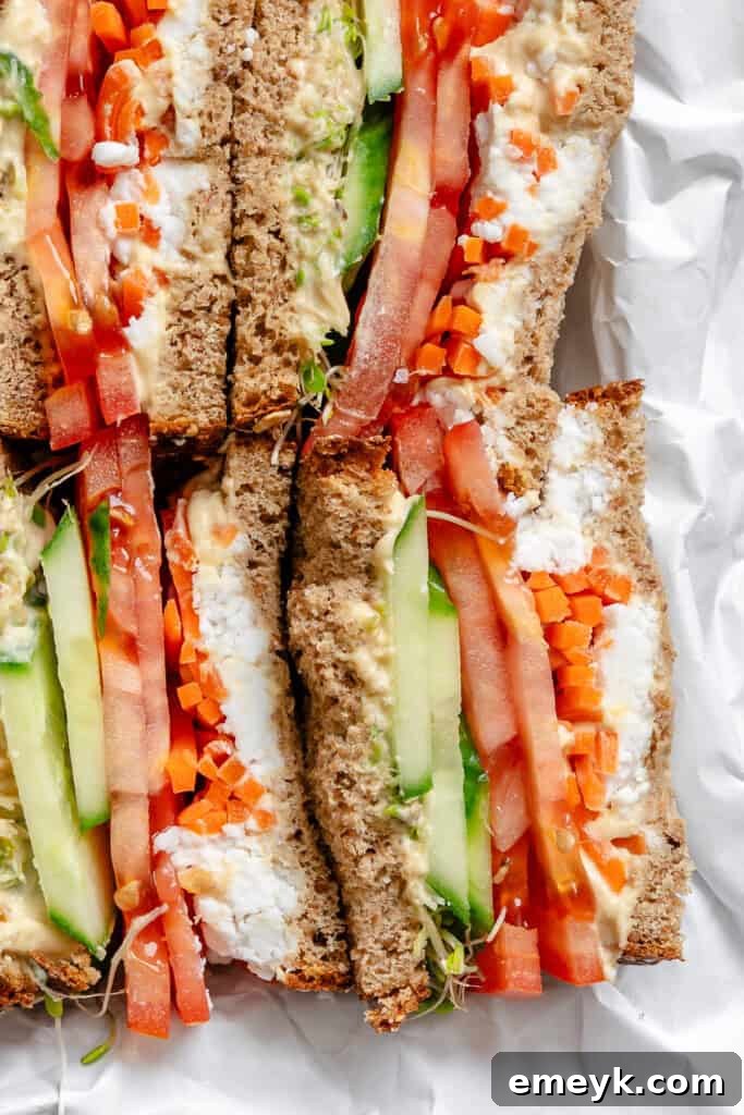 Two halves of a Mediterranean Vegetable Sandwich, showcasing the layers of fresh ingredients.