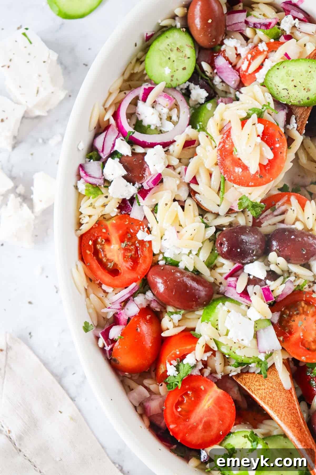 Close-up of Greek Orzo Pasta Salad with crumbled feta cheese.