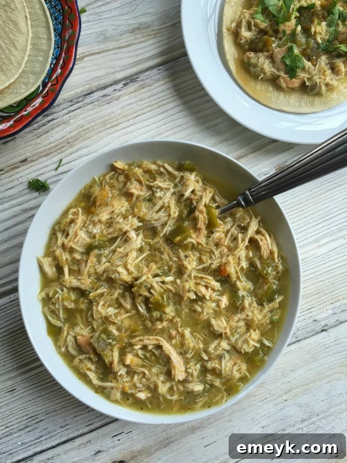Simmered Salsa Verde Chicken Tacos 2 Slow Cooker Salsa Verde Chicken Tacos, garnished with fresh cilantro and lime